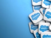 Logos of the company salesforce which offers cloud based solutions for Customer Relationship Management on a heap on a table.