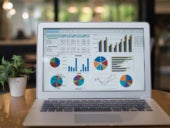 Accounting software featuring different graphs and charts on laptop display.
