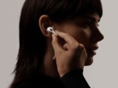 Woman trying on an airpod on her right ear.